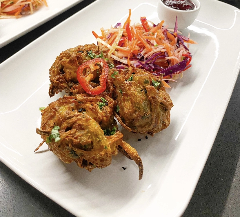 Spiced Onion Bhaji’s Served With A Raw Slaw And Tamarind Chutney