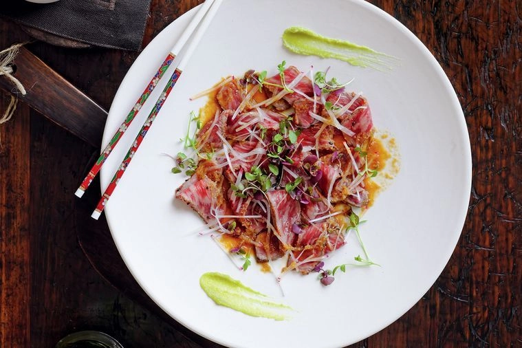 Beef Tataki With Onion’s Sake Ponzu, Smacked Cucumber, Garlic Crispy, And Wasabi Emulsion