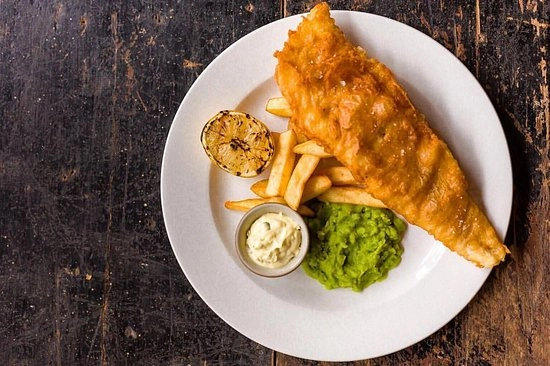Fish And Chips Served With Pea Puree And Tatar Sauce