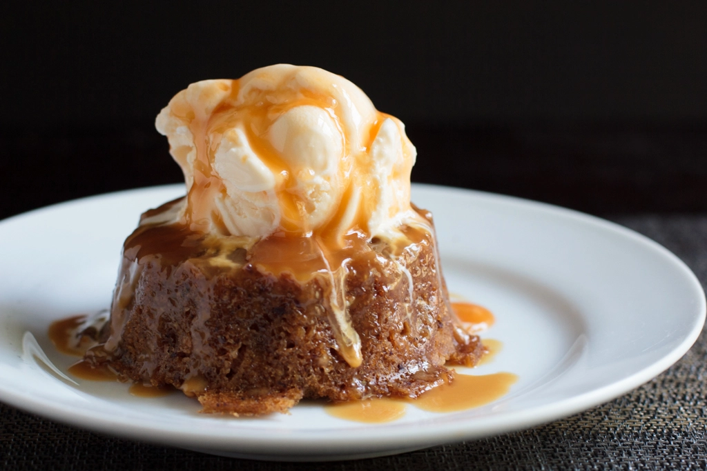 Sticky Toffee Pudding Served With Carmel Sauce And Vanilla Ice Cream