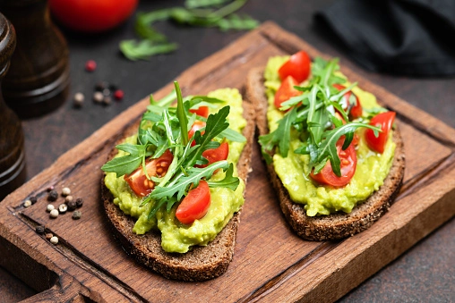 Smashed Avocado On Sourdough Toast With Roast Vine Tomatoes (Ve)