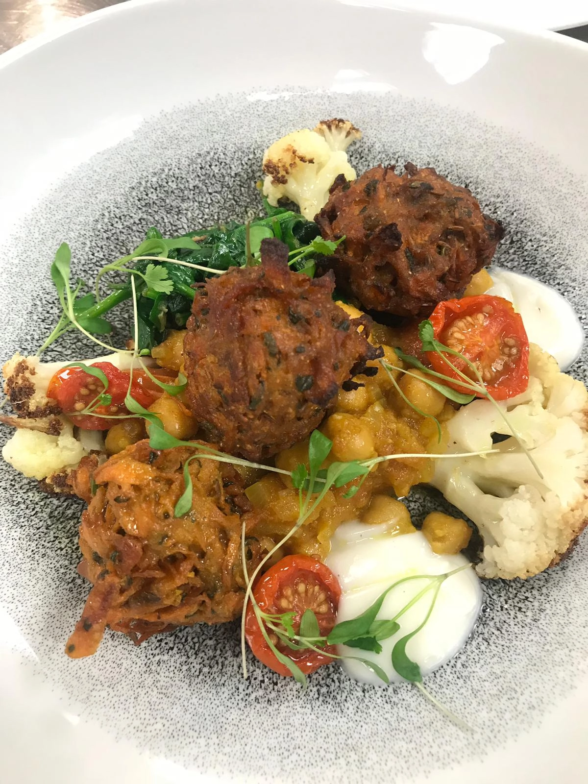 Pakoras With Chana Dal, Curried Cauliflower, Wilted Spinach And Roasted Heritage Tomatoes