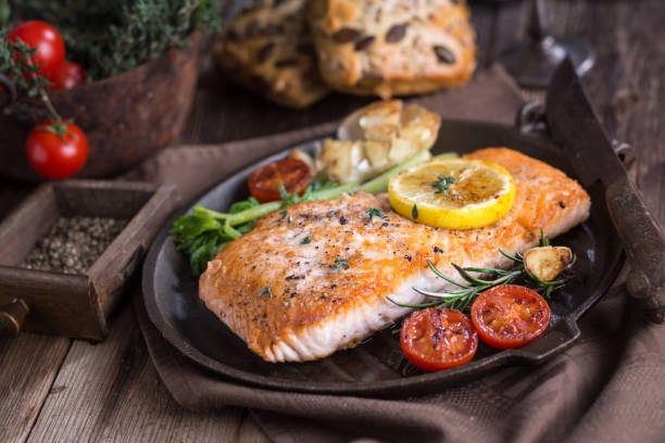 Grilled Salmon Or Truite With Cherry Tomatoes And A Light Butter Lemon Sauce With Fresh Rolls