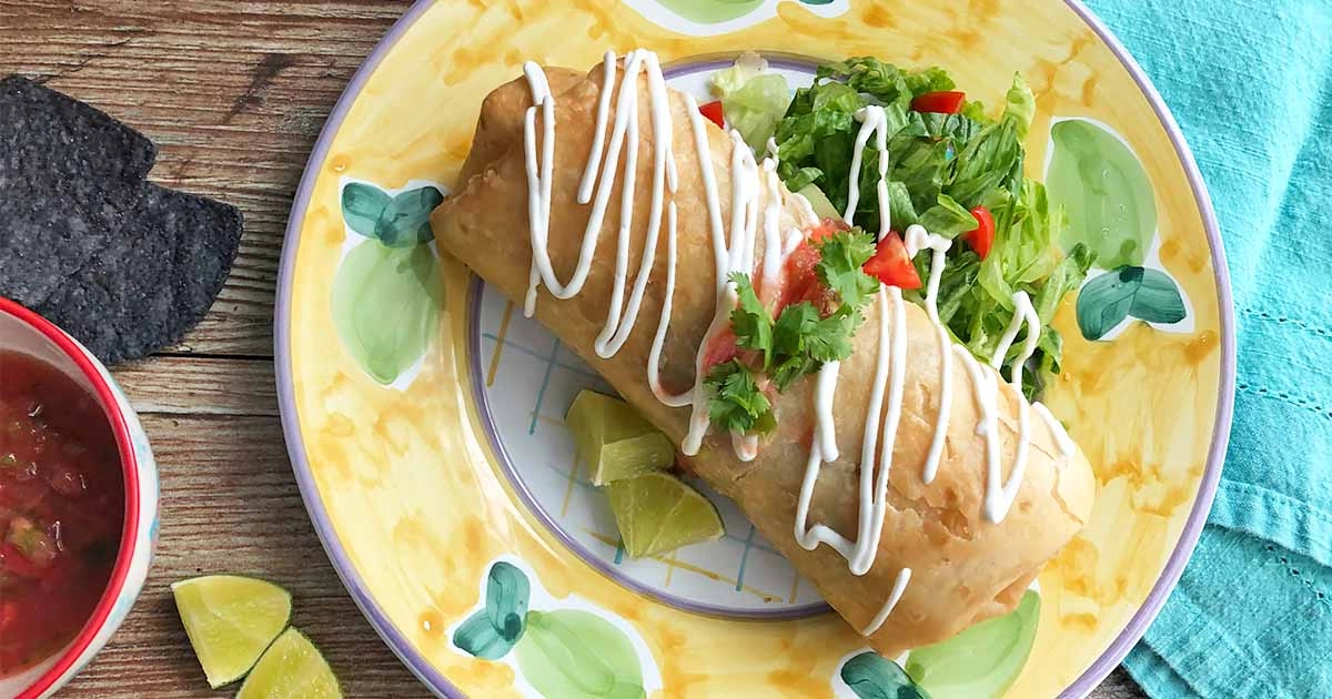 Pan-Fried Cheesy Chimichangas With Minced Beef, Topped With Sour Cream And Guacamole