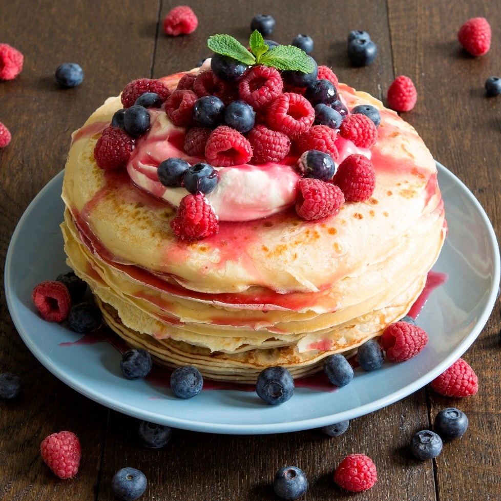 Pancake Served With A Fresh Mix Of Berries, Berries Coulis And
Vegan Ice Cream
