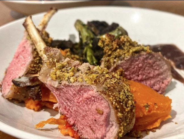 Pistachio Crusted Lamb With Dauphinois Potatoes Served With Broccoli Spears And A Red Wine Gravy