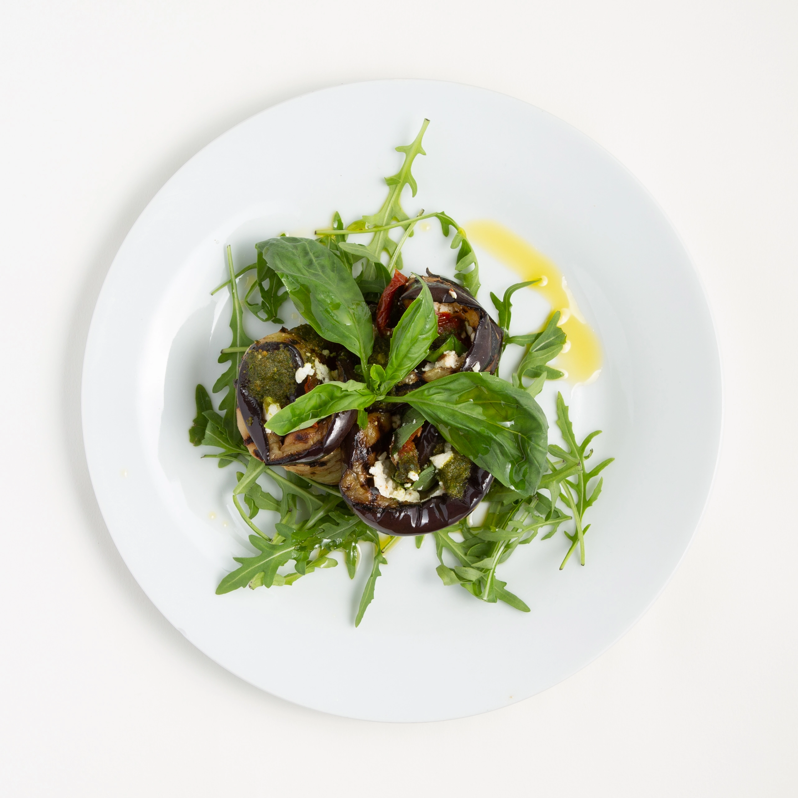 Grilled Roll Aubergine, Filled With Sun Dried Tomato Feta Cheese On A Bed Of Mixed Crisp Salad And Basil Pesto Dressing. (V) Can Be Vegan.