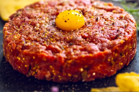 Classic French Steak Tartare Pickles Rocket Salade And Baby Roasted Potatoes With Herbs