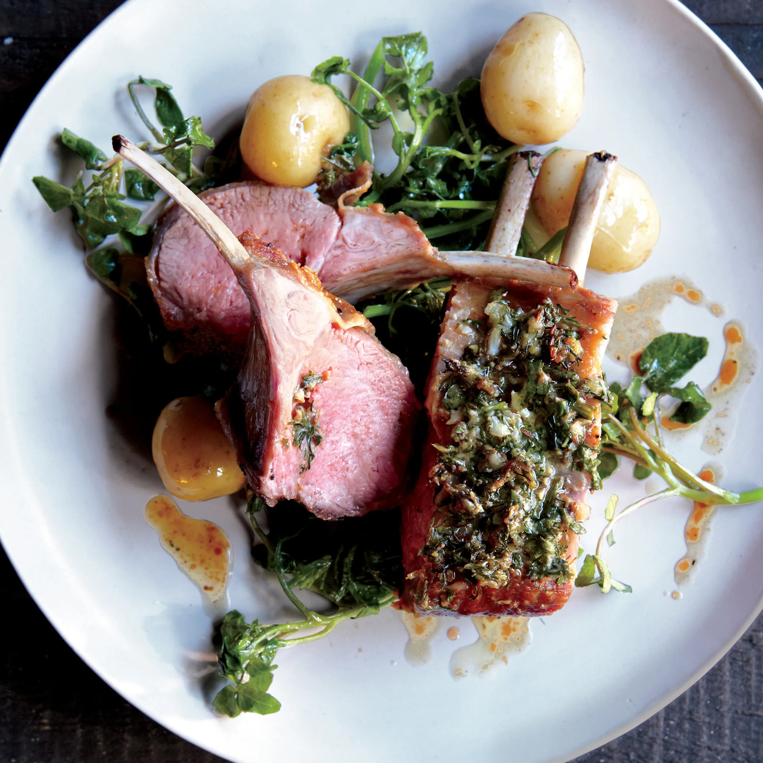 Herb Crusted Rack Of Lamb Served With Roasted New Potatoes, Green Beans And A Lamb Jus