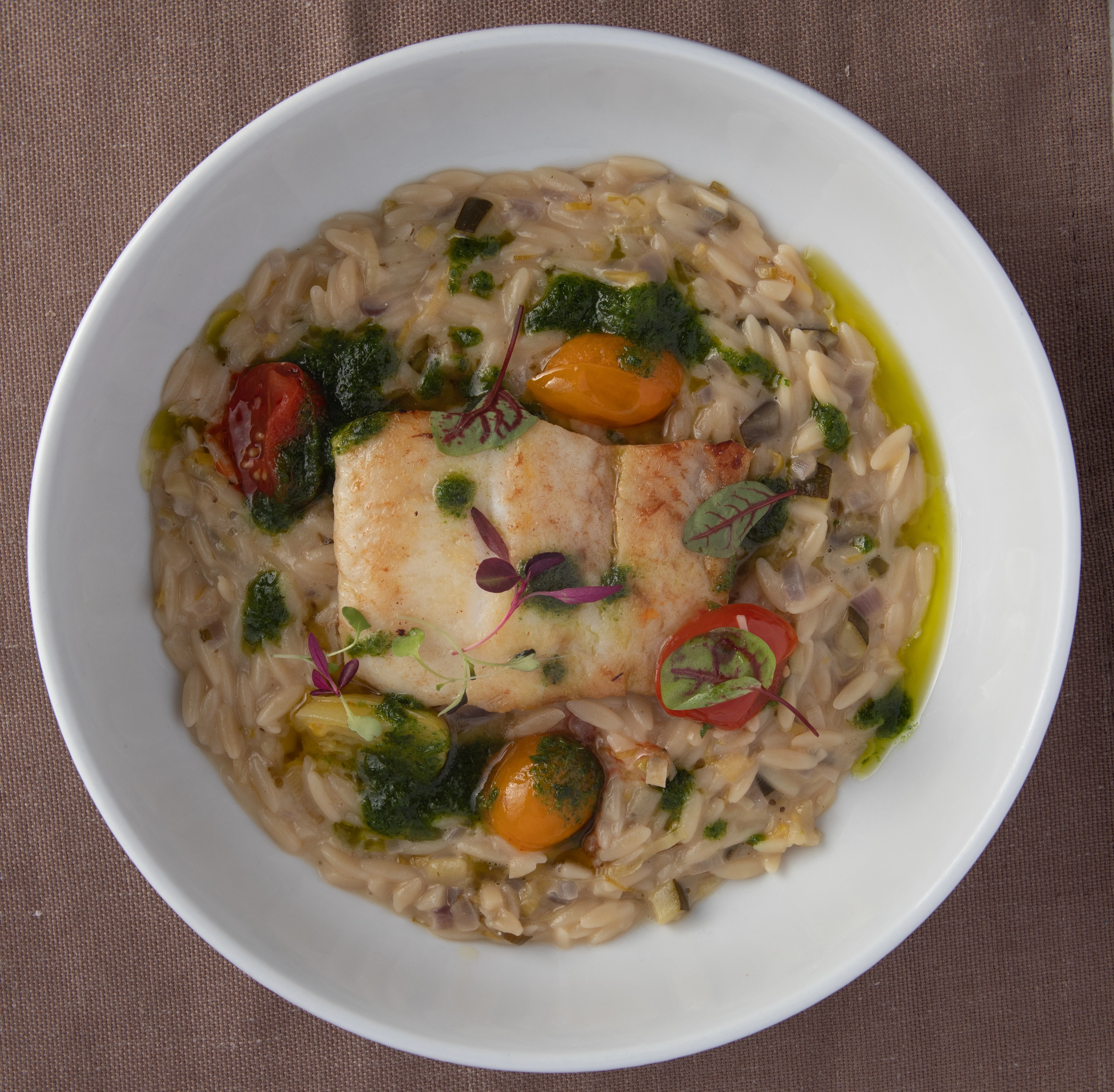 Pan-Fried Sea Bass With Vegetable Orzito, Confit Tomatoes & Chive Oil