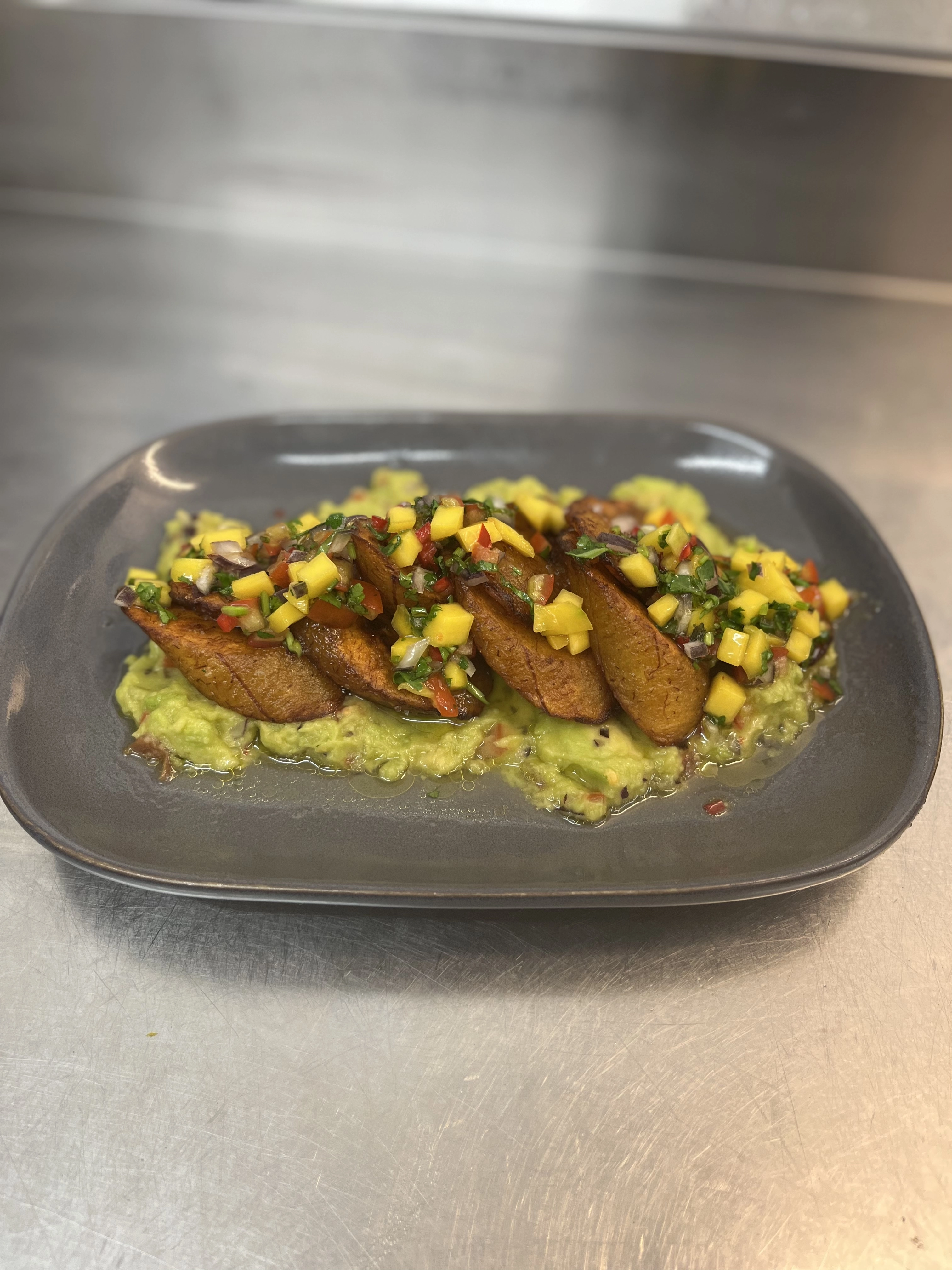 Fried Plantains On A Bed Of Guacamole And Mango Salsa