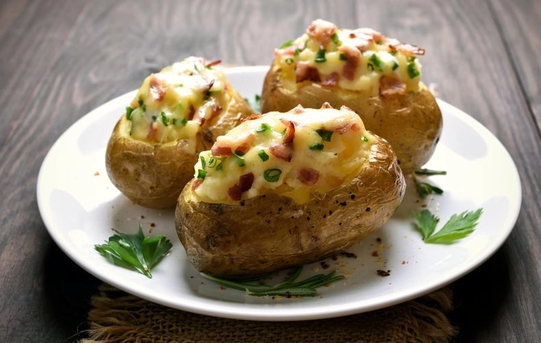 Jacket Potatoes Served With Cheddar And Bacon