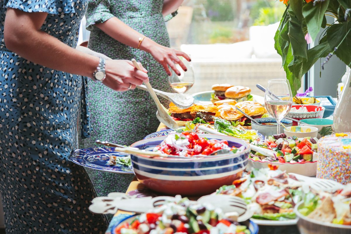 Summer buffet with guests serving themselves at home